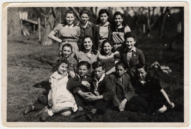 group of young teenagers poses on the grounds of the Rosenheim displaced persons' camp.1946